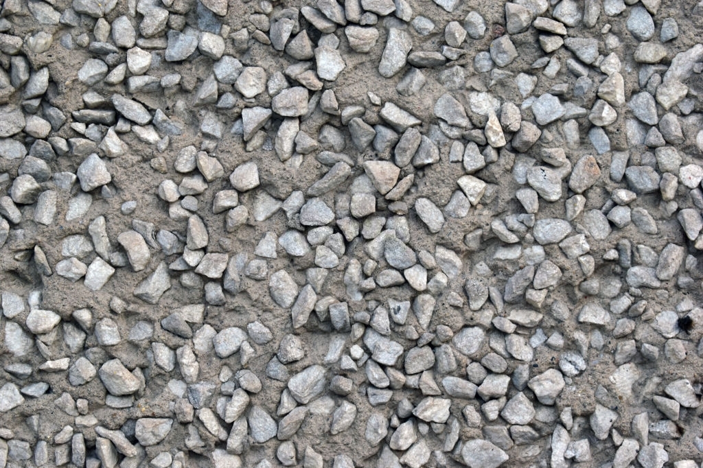 Grey old surface of asphalt and concrete wall